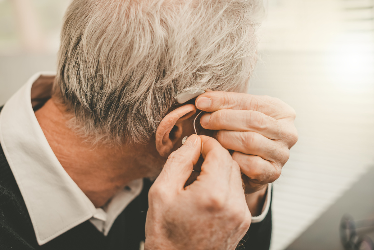 Man putting hearing aids